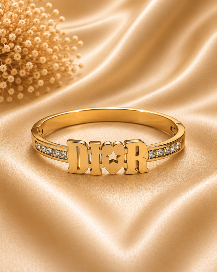 One Crossover Twist Bangle in Gold on champagne satin