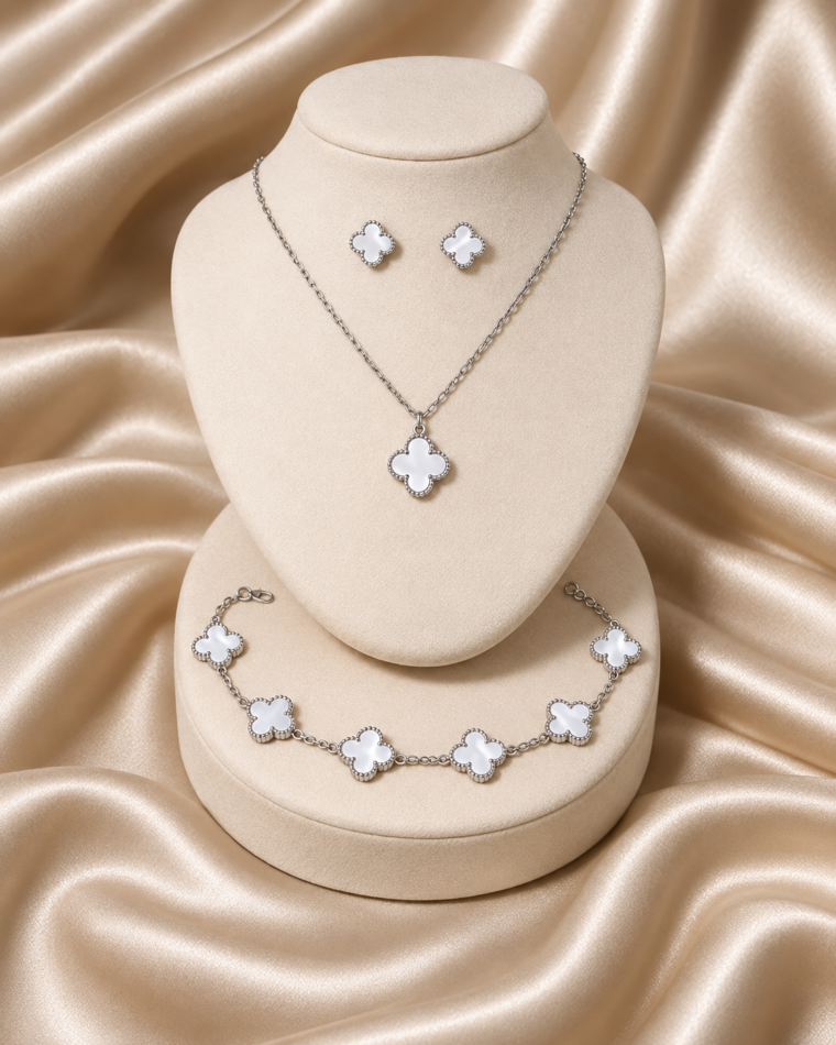 One complete Four-Point Clover Set in White, with silver-tone necklace, bracelet and matching stud earrings
