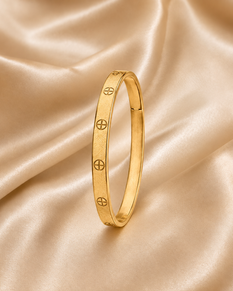 One Textured Zirconia Bangle in Gold on champagne satin