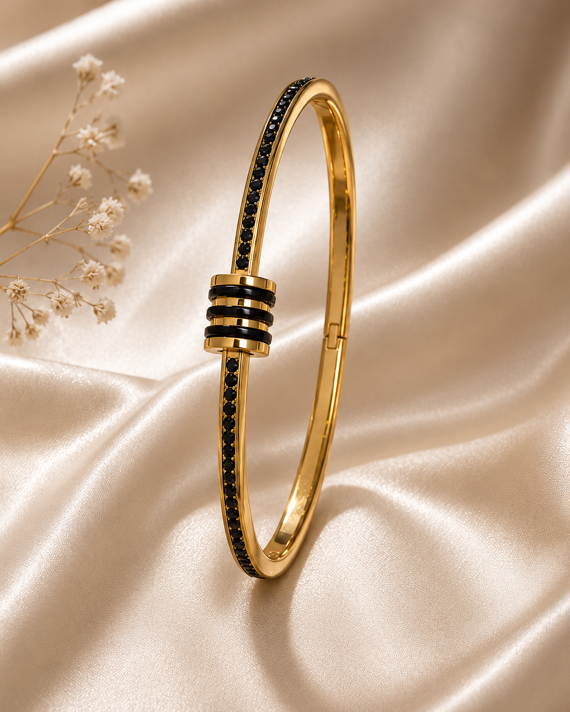 One gold and black triple-band zirconia bangle on champagne satin